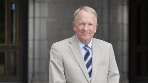 Dr. Gregory Postel stands in front of main entrance to University Hall
